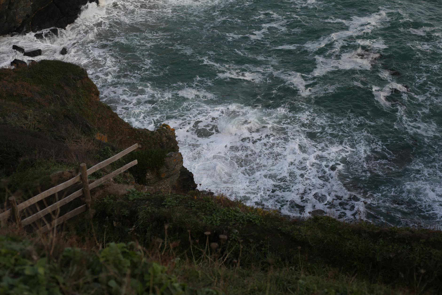 Dramatic Cornwall coastline with rugged cliffs and blue ocean viewed from the coastal path