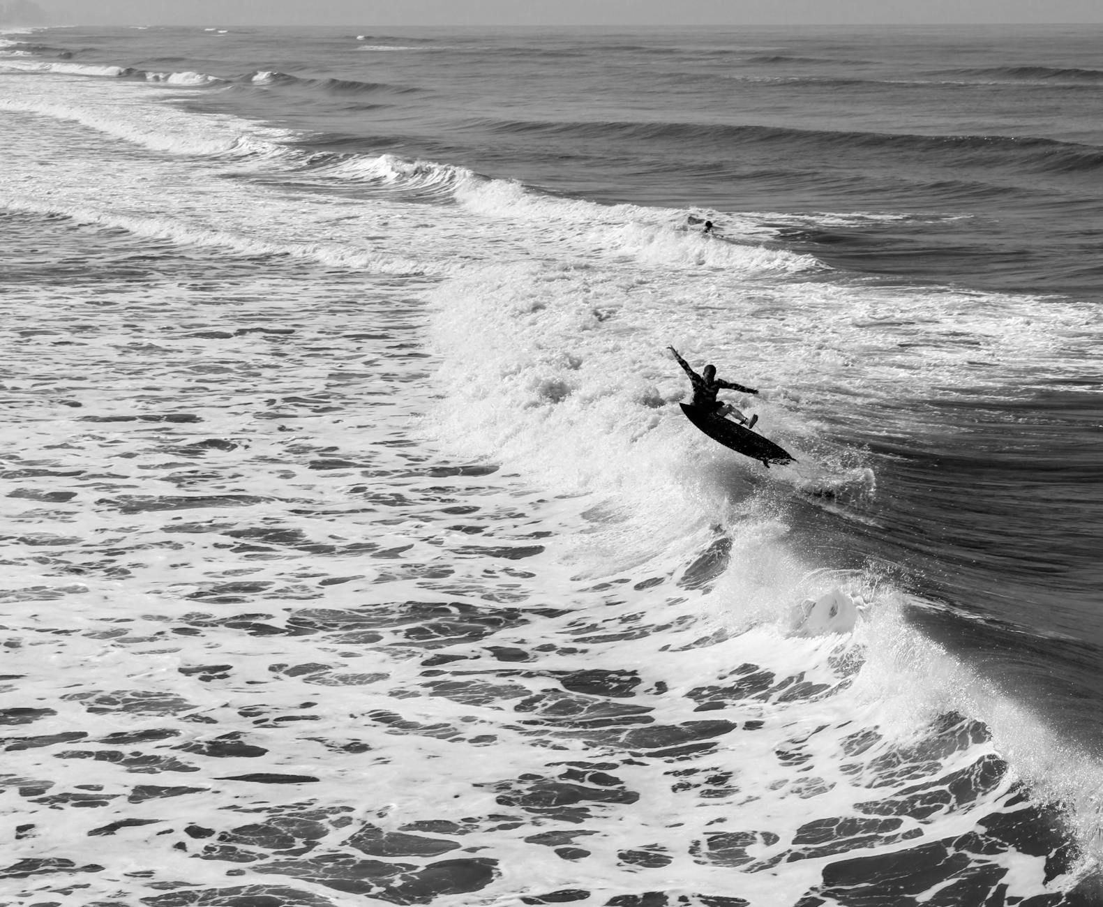 Surfers riding waves at Fistral Beach near Newquay Cornwall