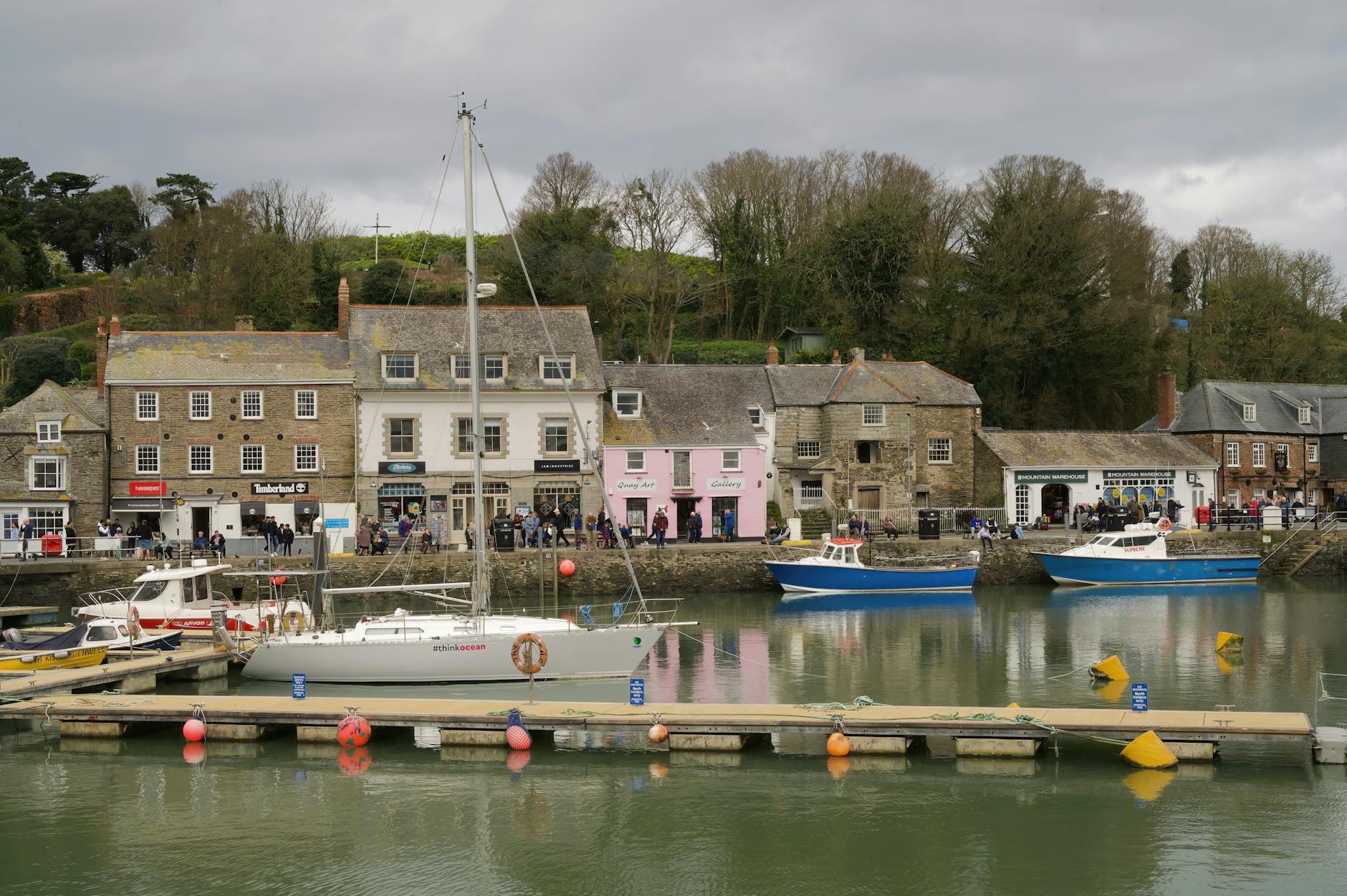 Colourful boats in Padstow harbour Cornwall with the town in the background