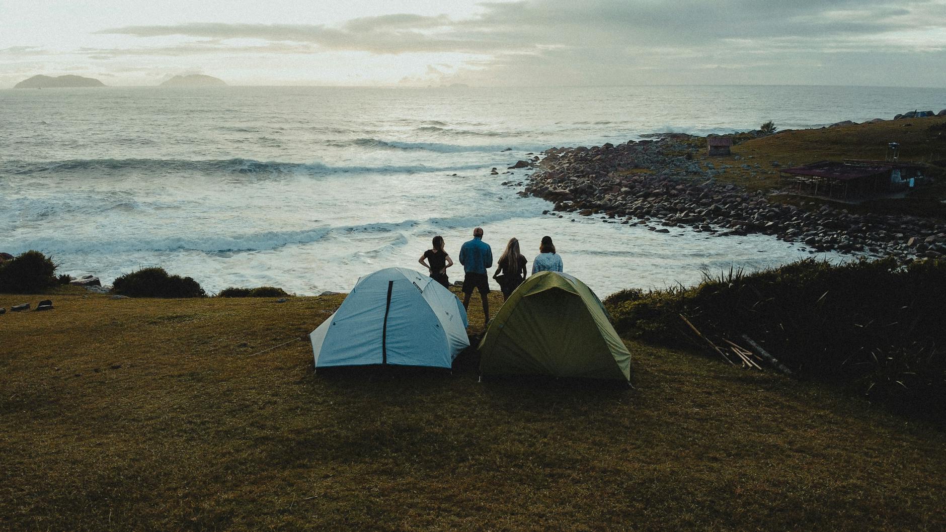 Family holidays Cornwall camping tent at scenic coastal sunset