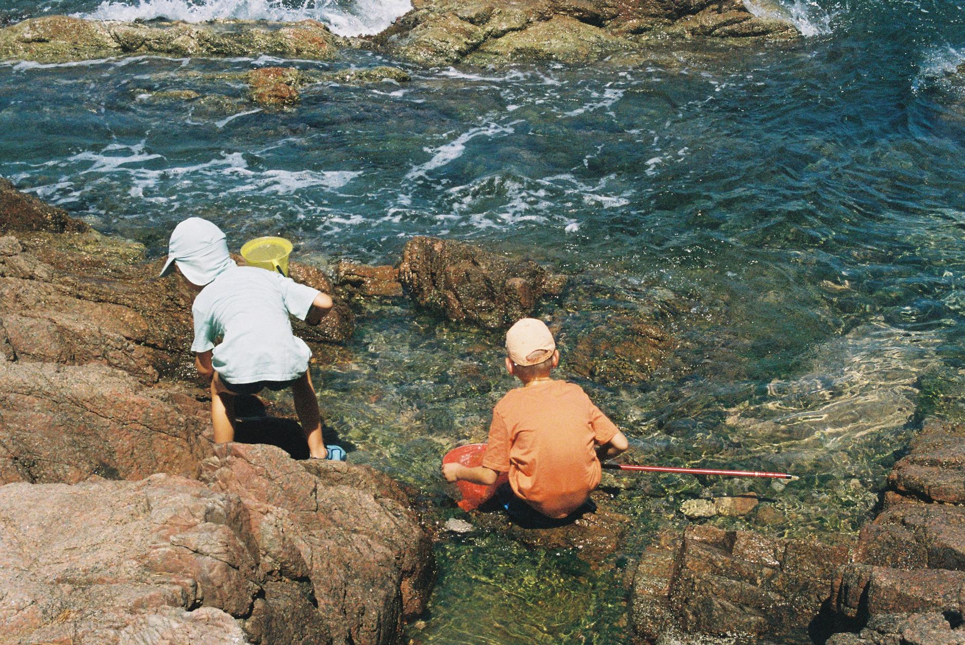 Family holidays Cornwall rock pooling exploring children at coast