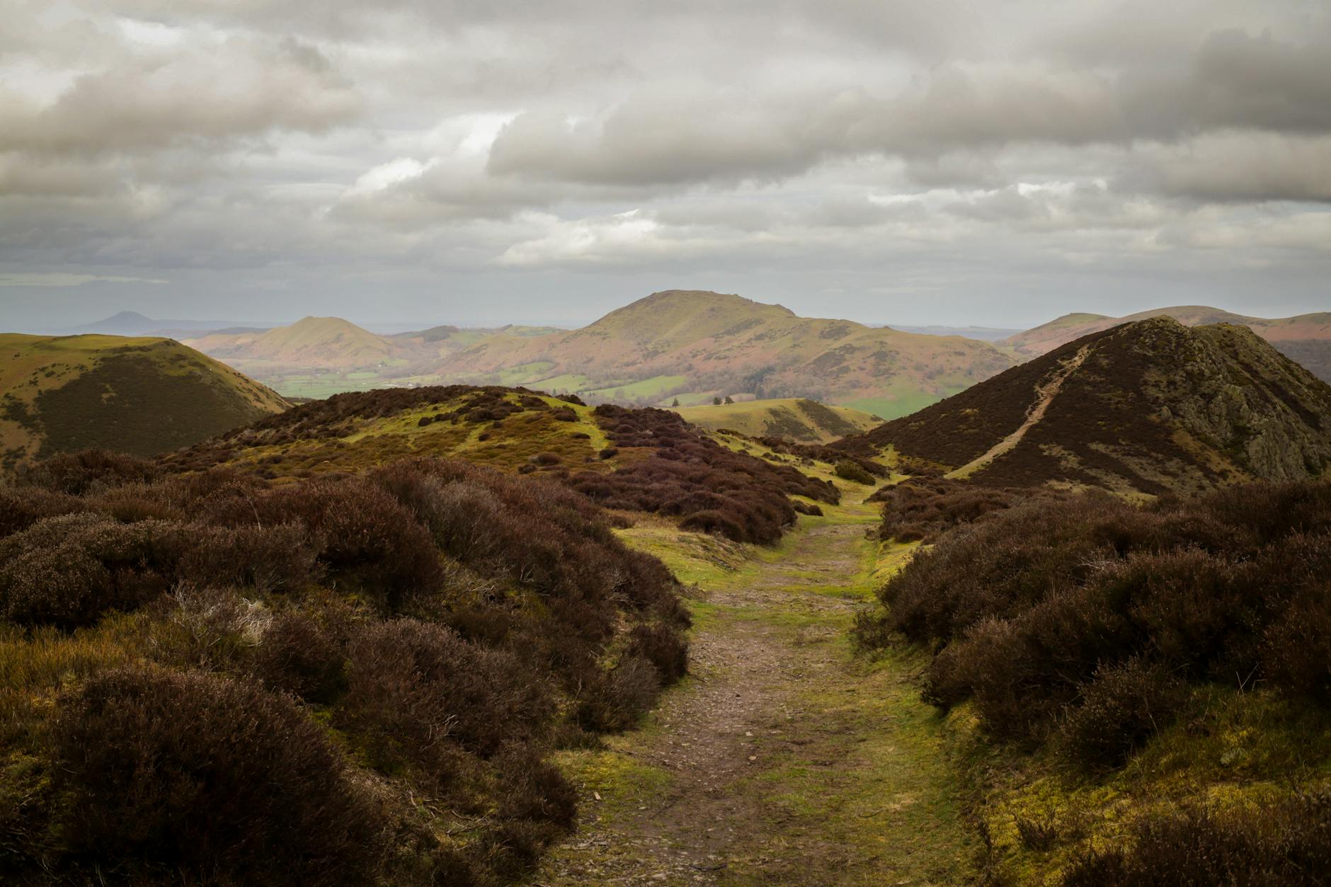 Walking across the wild open moorland of Bodmin Moor Cornwall with granite tors