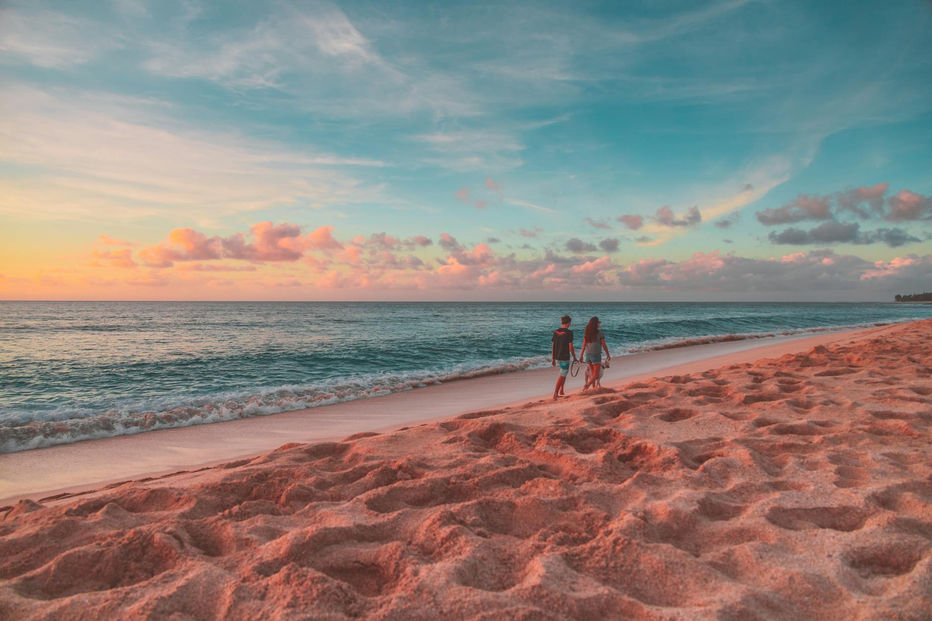 Couple enjoying a romantic beach walk along the Cornwall coast