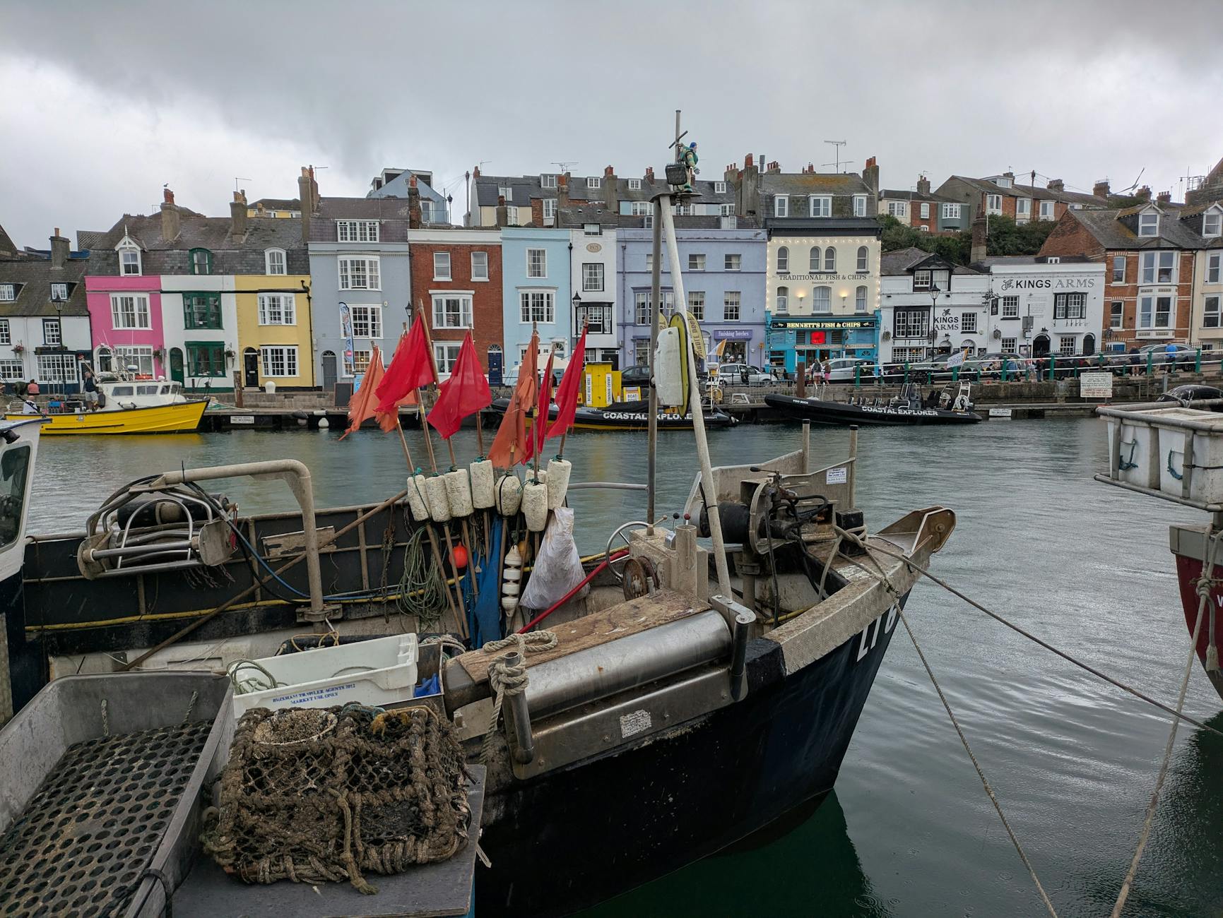 Children crabbing harbour wall Cornwall