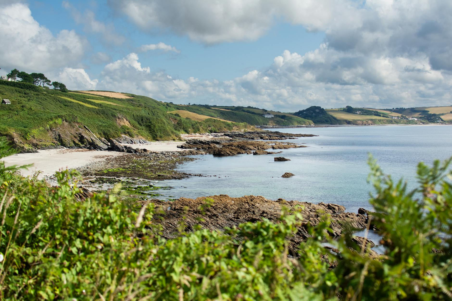 Cornish beach and turquoise sea on a sunny day, showing the best time to visit Cornwall
