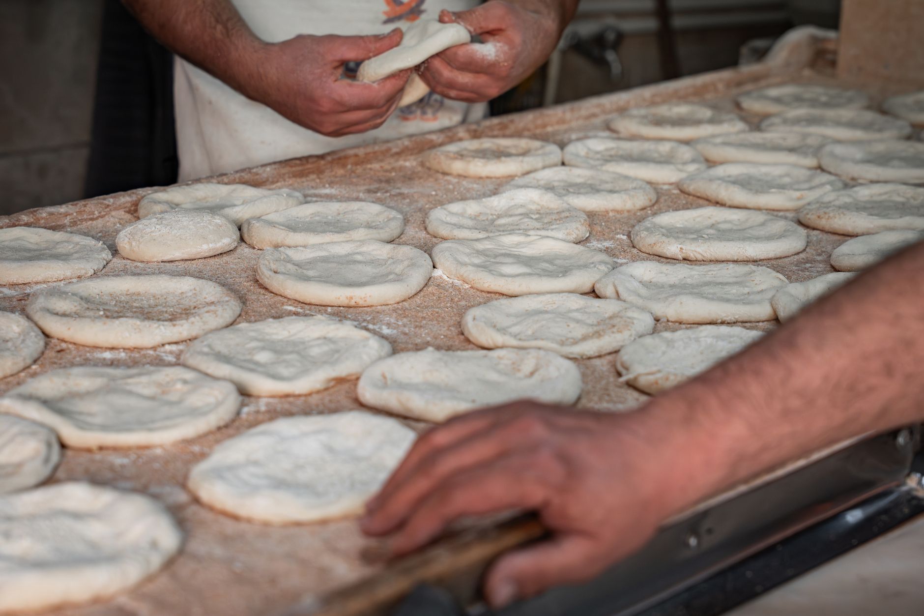 A baker crimping the edge of a Cornish pasty by hand