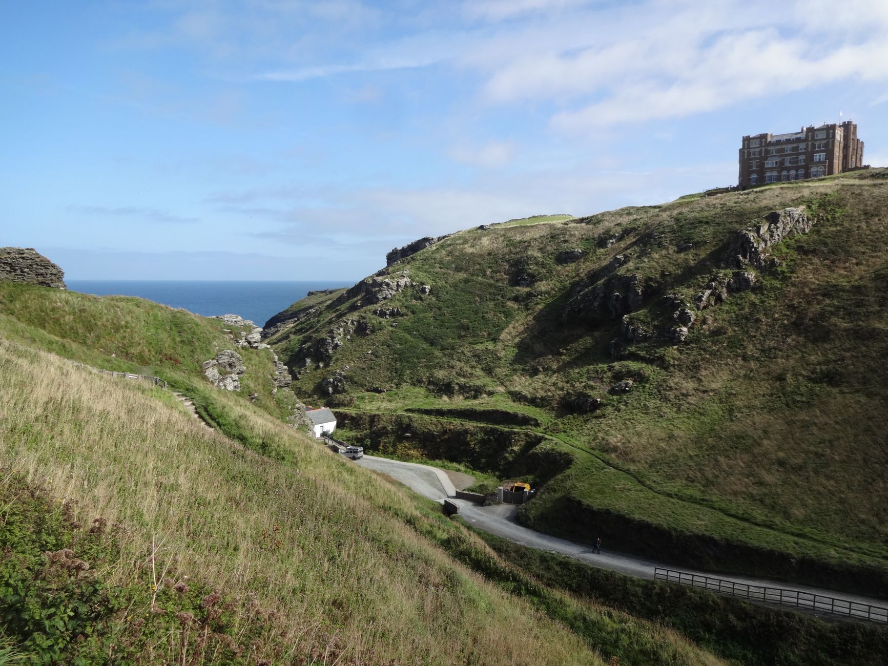 A narrow lane winding through the Cornish countryside towards the coast