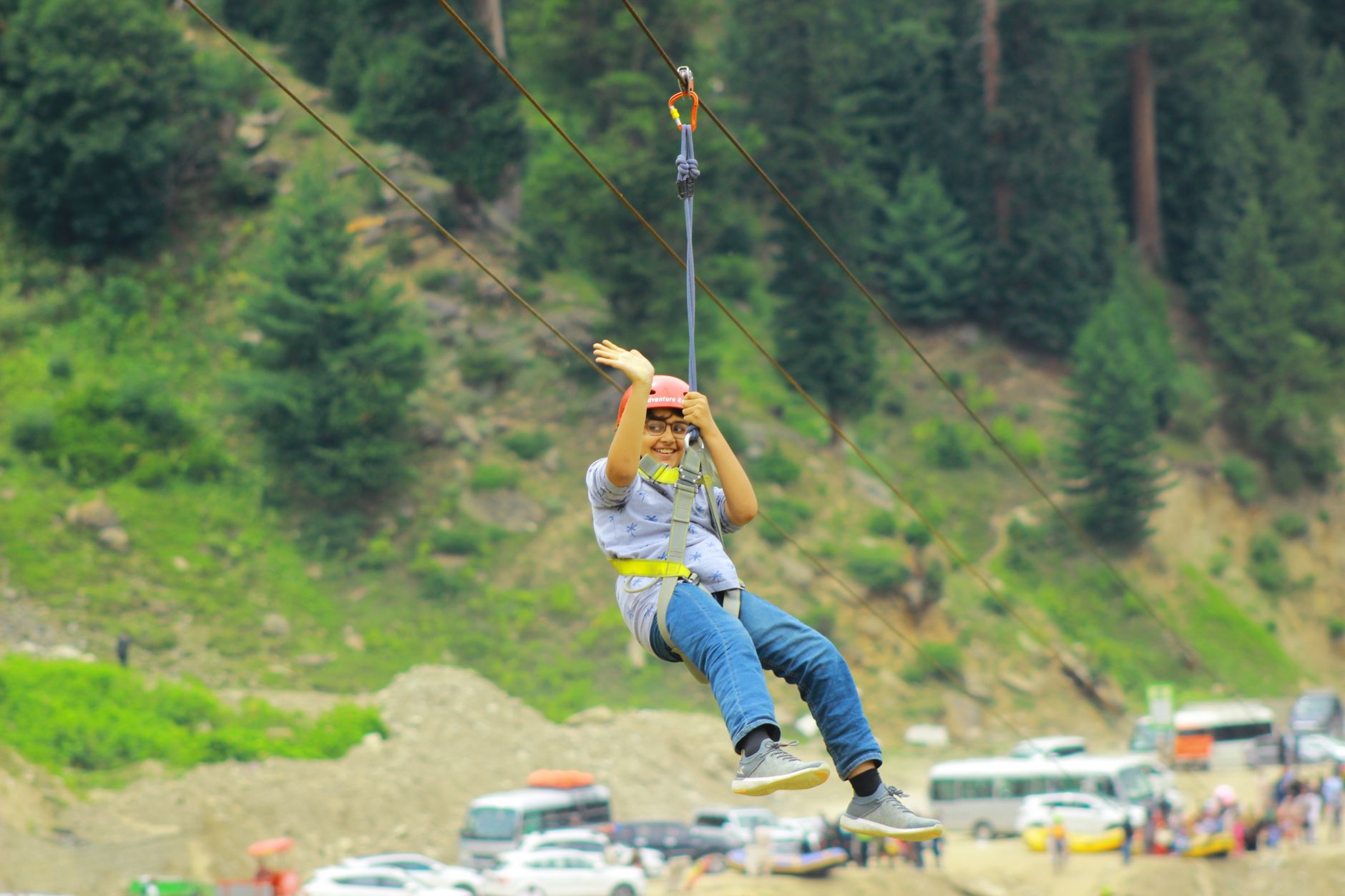 A rider on a long zip wire stretched across a flooded quarry