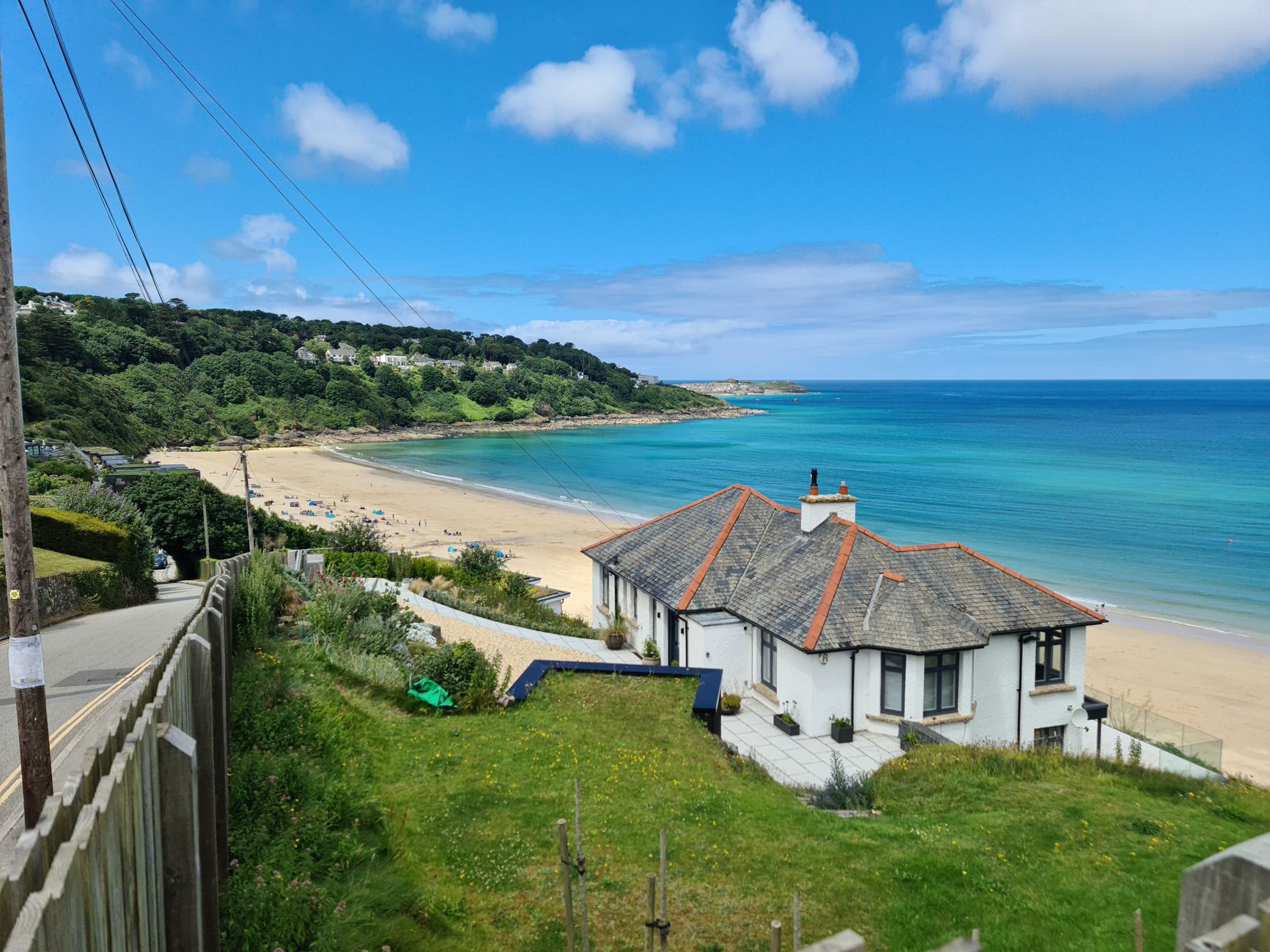 Calm turquoise water and pale sand at Carbis Bay, one of the best swimming beaches in Cornwall