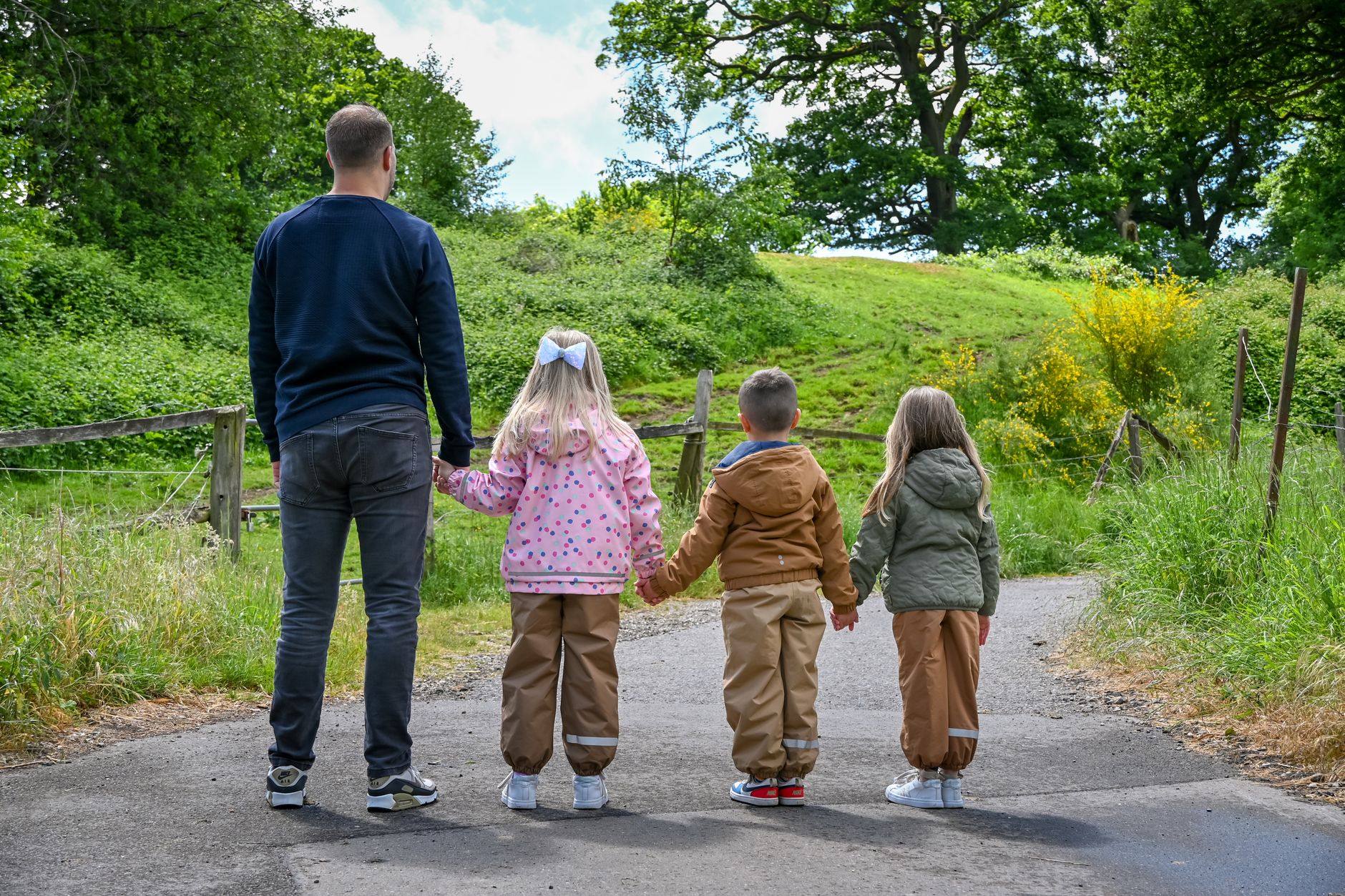 Family walking a flat traffic-free trail with a pushchair on an easy Cornwall walk