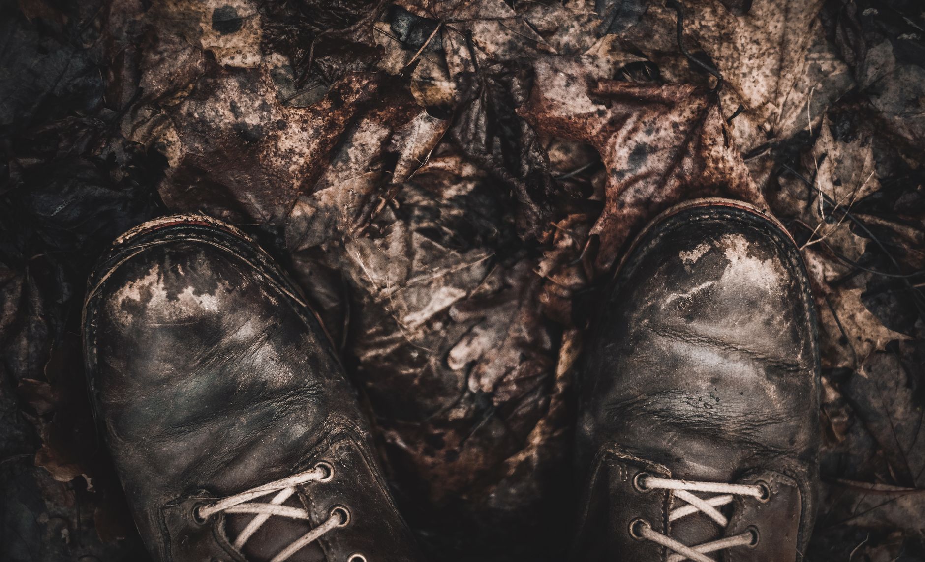 Waterproof walking boots on a wet, muddy Cornish path