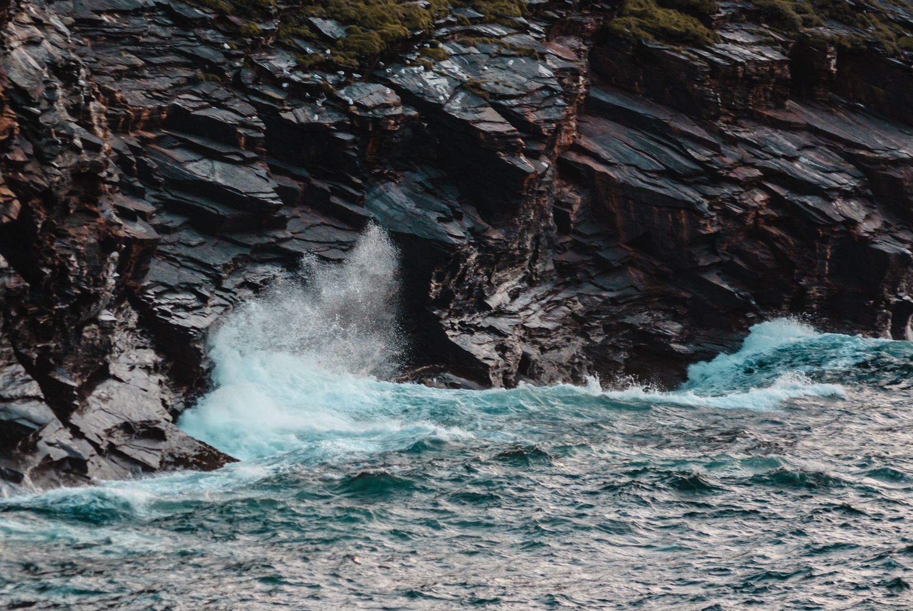 Winter storm waves breaking against a Cornish harbour wall