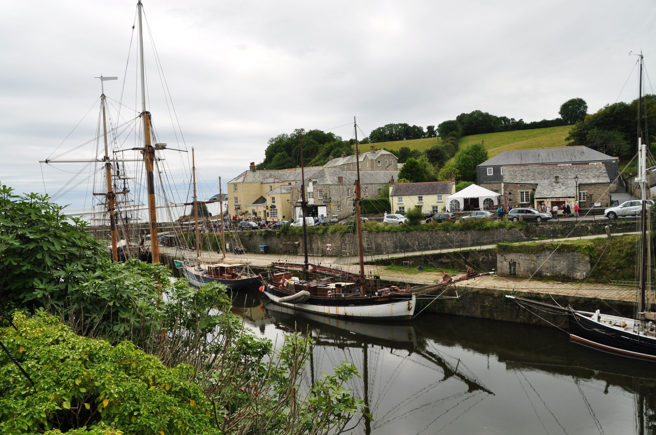 Tall ships moored in the Georgian harbour at Charlestown, Cornwall