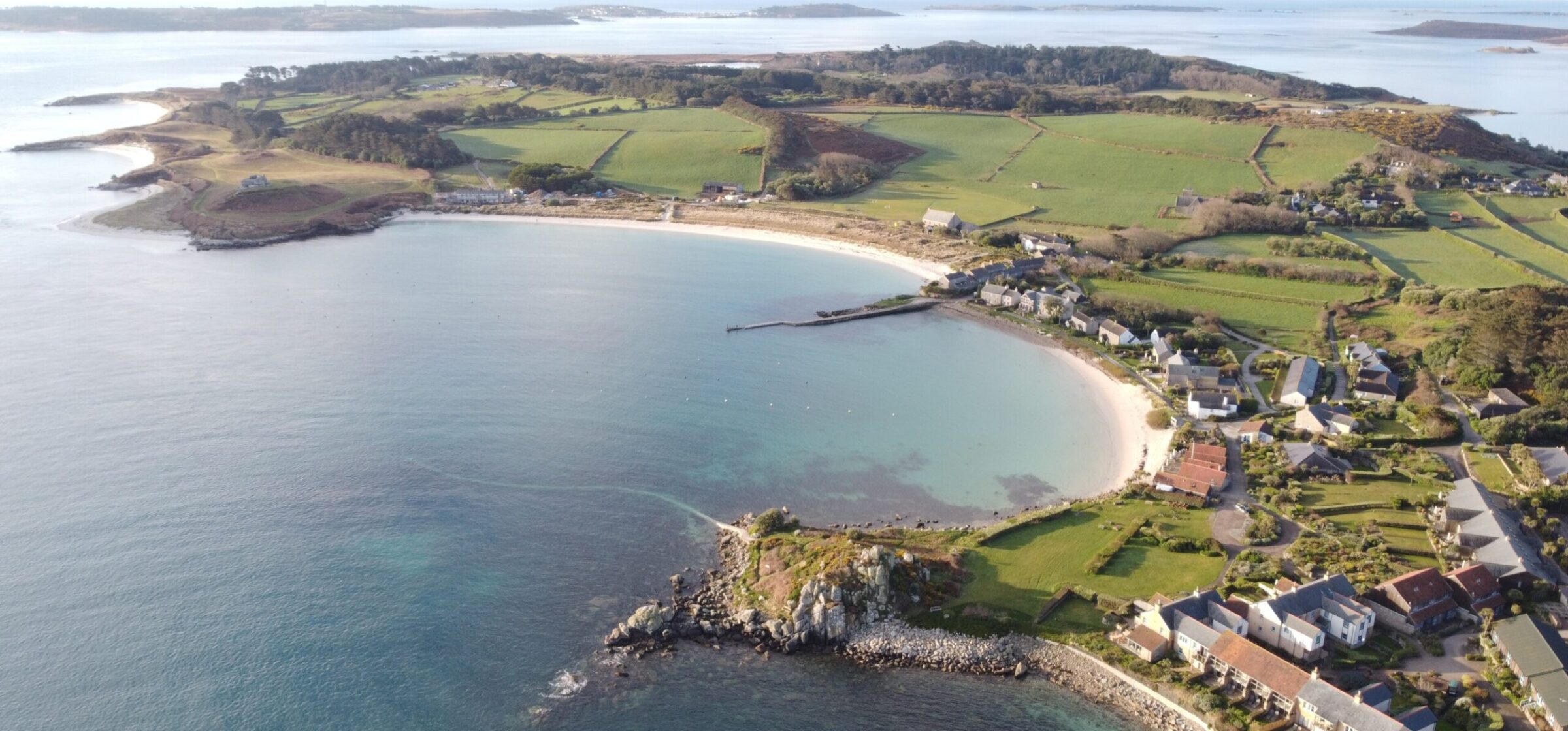 Aerial view of the white sand bay and cottages at Old Grimsby on Tresco, Isles of Scilly