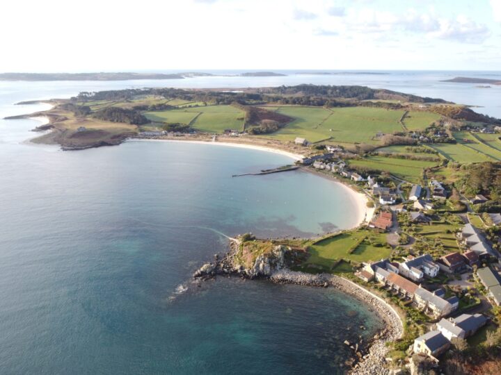 Aerial view of the white sand bay and cottages at Old Grimsby on Tresco, Isles of Scilly